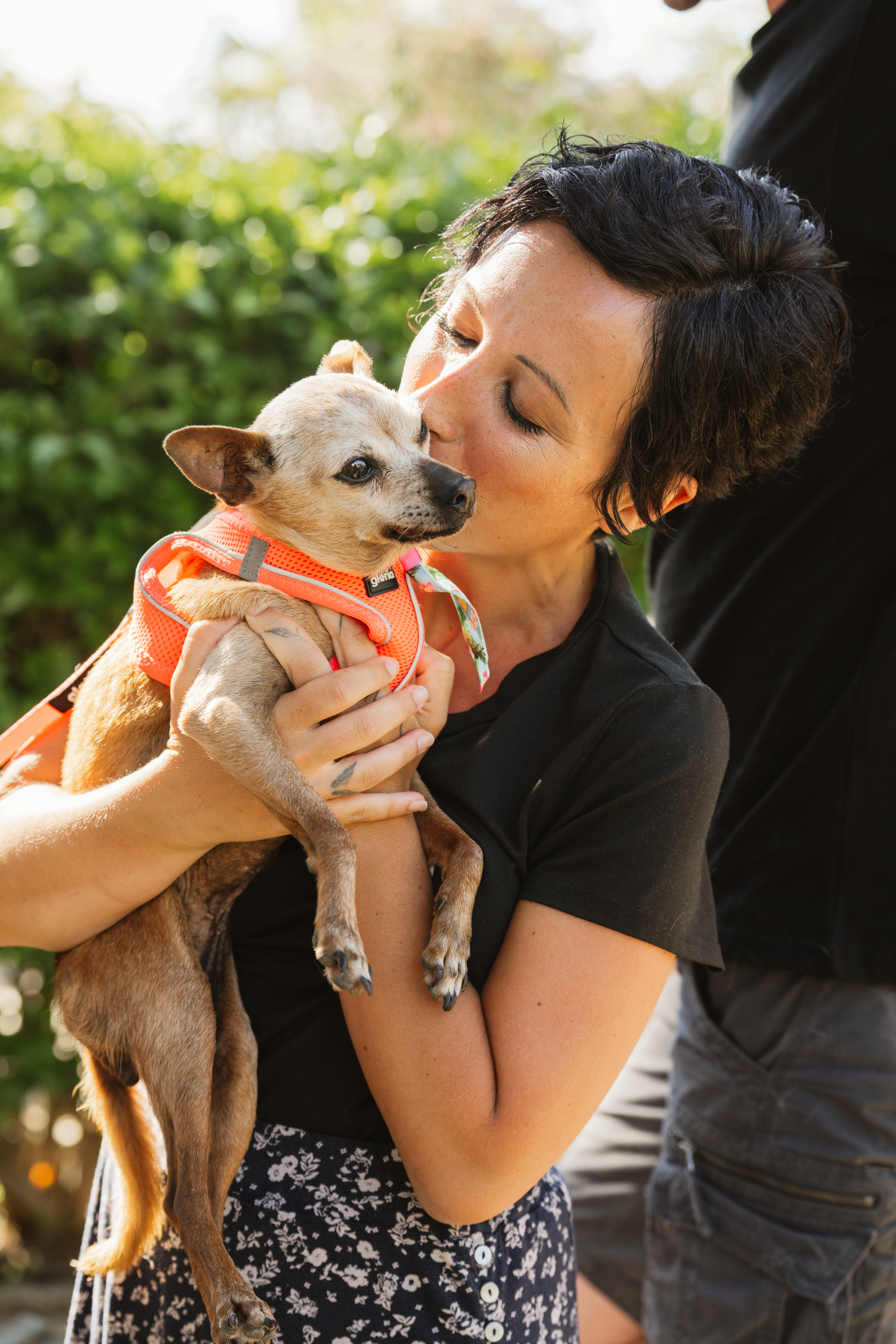 Katya kissing her dog outdoors